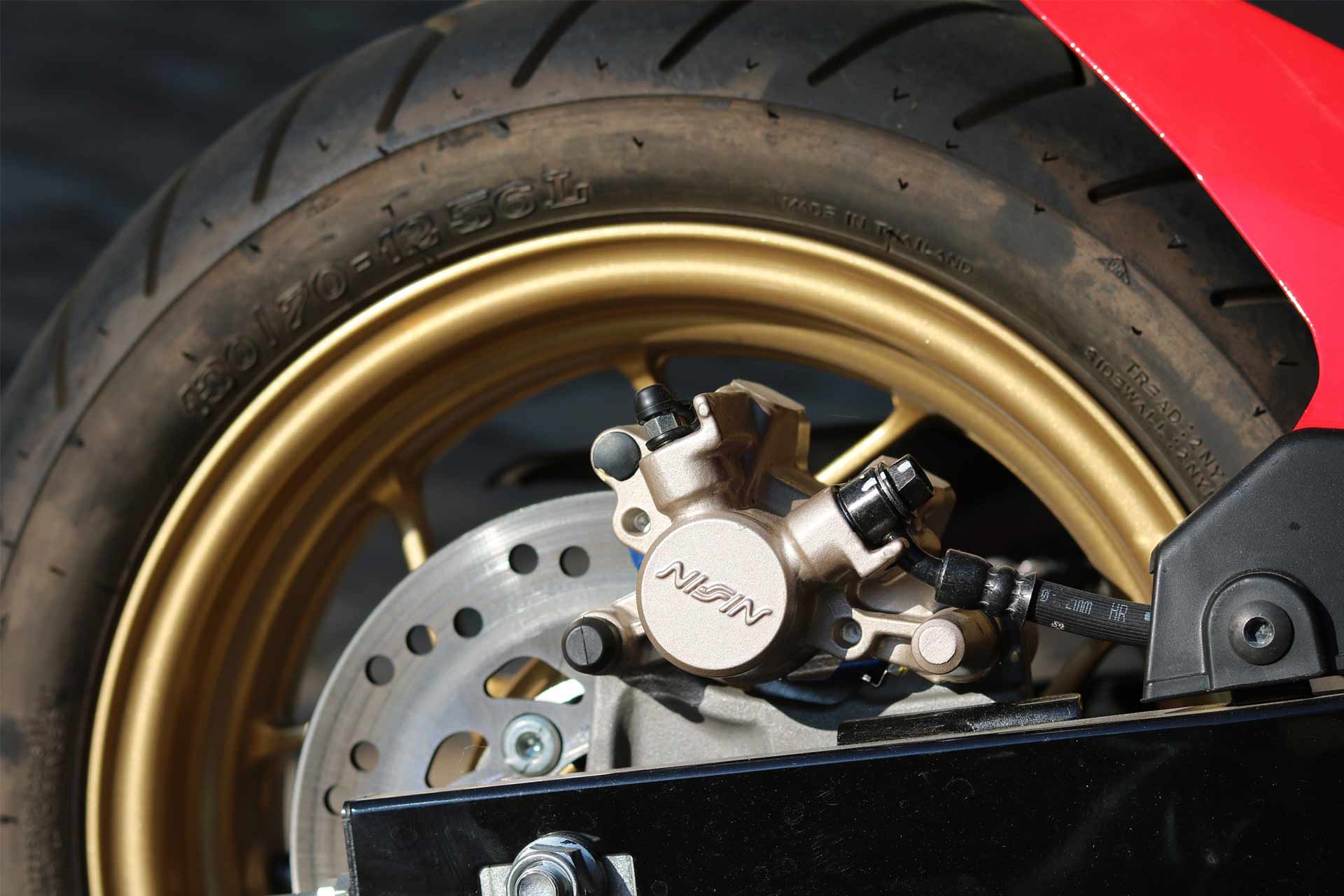 Zoomed in image of a motorcycle's rear wheel with emphesis on the rim and the brake disc